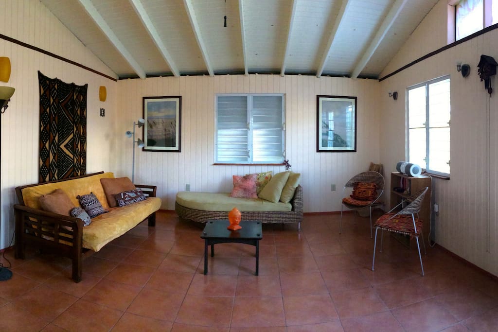 The living room with comfy chaise lounge and full size pull out futon couch where extra guests can sleep.