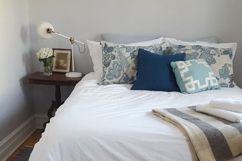 Queen bed with down duvet and high quality bedding.