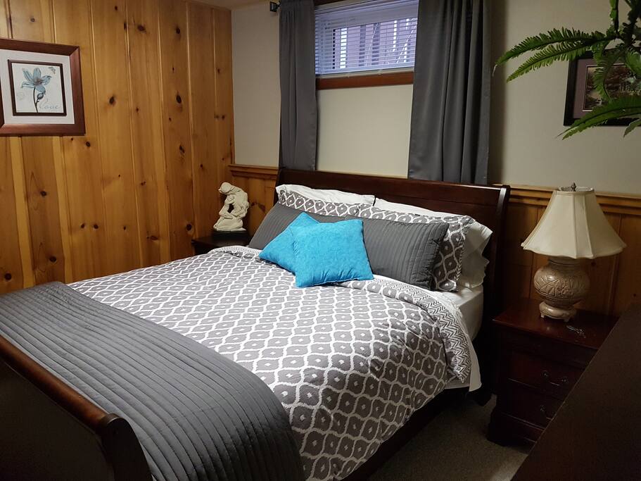 Large bedroom with sleigh bed, 5 drawer dresser, full length mirror and very large closet complete with ironing board and hangers