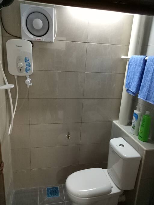 Bathroom 1 - water heater, hair & body shampoo, towel, hanging rack...