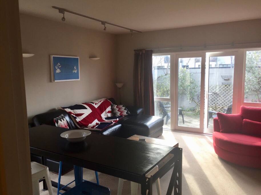 Living room and lounge on ground floor looking out to courtyard, grab on a sunny afternoon