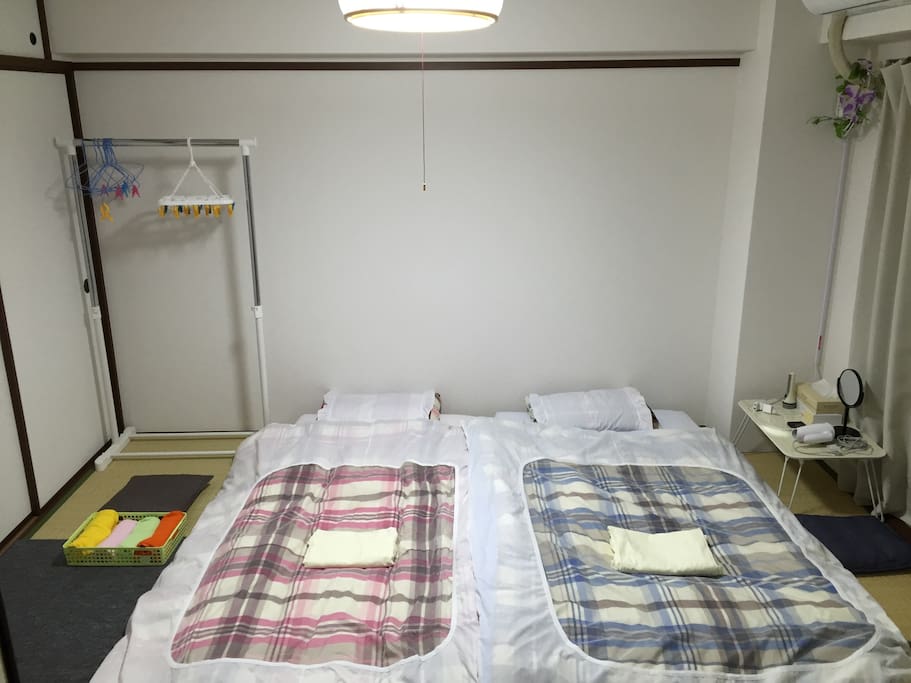 Your air-conditioned room with two futon beds (with mattresses) spread out (when 2 persons).