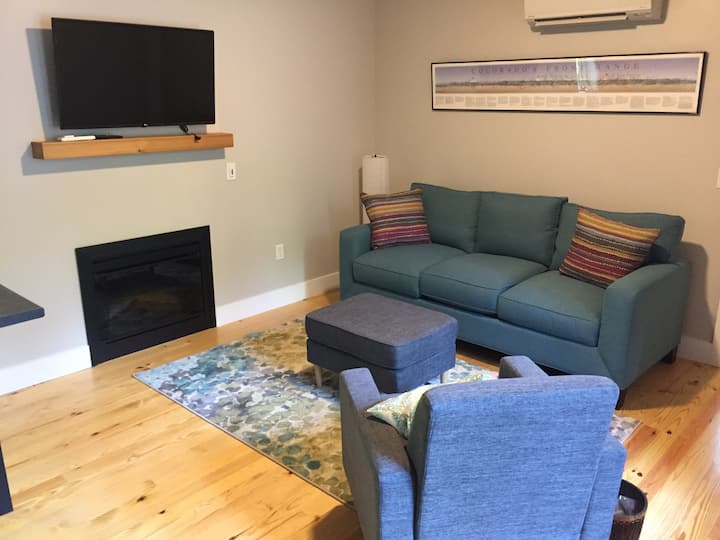Cozy living room for snuggling in with friends and family in front of the  fireplace or wifi-enabled TV for a good movie. Log into your Netflix or Amazon video accounts right from tv. 