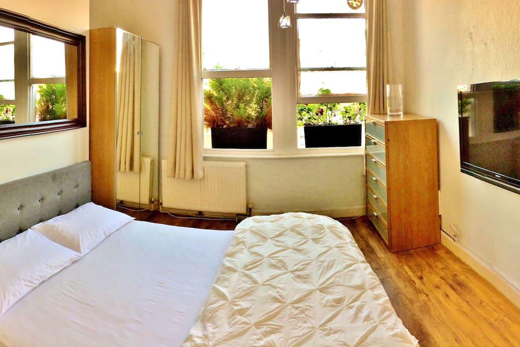 Rest after a long walk around London in this bright and spacious bedroom. 2 windows, tons of storage space just for you and a big TV.