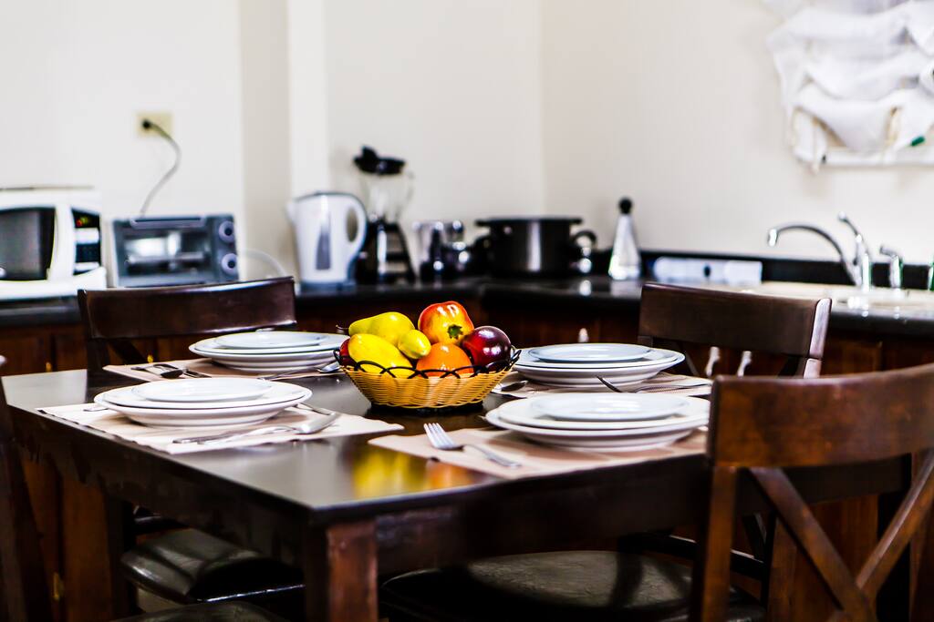 Kitchen with mini appliances, pots, cutlery and crockery