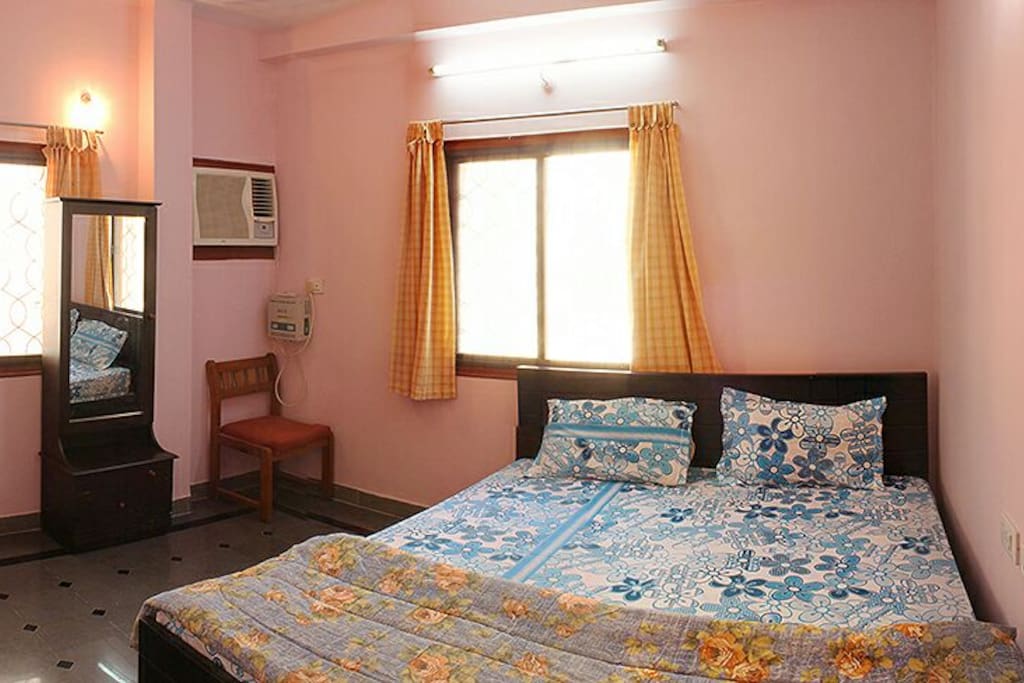 Master bedroom with attached European WC. Chairs, dressing table and wardrobe are provided.