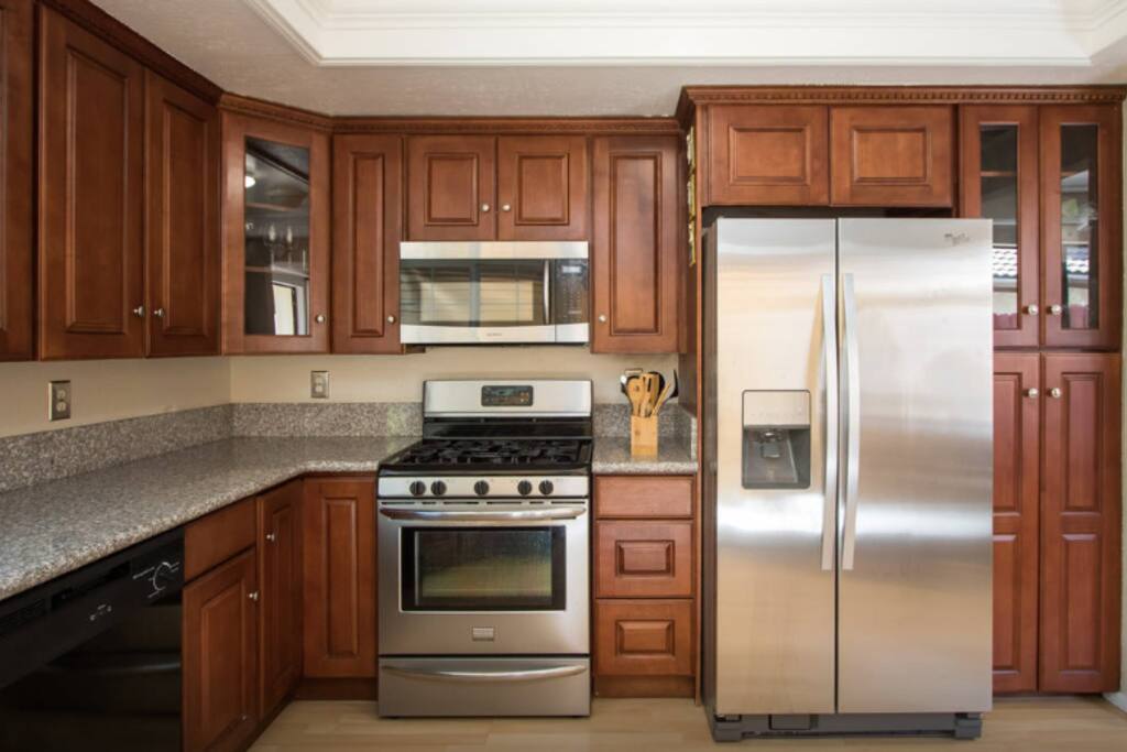 Newly-updated and neatly maintained kitchen, with brand new stainless steel appliances and granite countertop. Through the kitchen window you can enjoy the view of the backyard