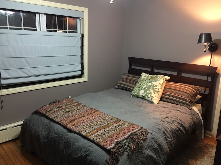 Ethan Allen queen size bed. Reading light. Wool Roman shade that pulls up or drops down for privacy. Cast iron baseboard radiant heat for warmth without drying. Goose down comforter