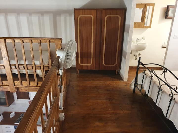 sleeping loft: wardrobe and single bed on the left
