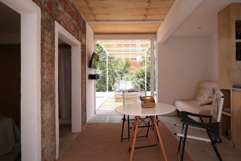 The glass sliding doors completely open for a fresh and sunny feeling.