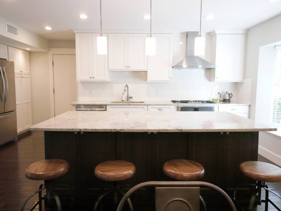 The heart of the house: a chef's dream kitchen! Large open floor-plan kitchen with bar seating for 4 and table seating for 6, plus all the appliances and gadgets you could want or need.