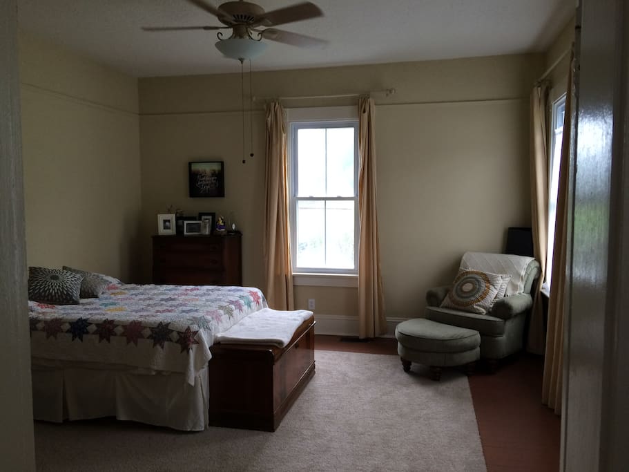 Large bedroom with sitting area and queen-size bed. Downstairs.