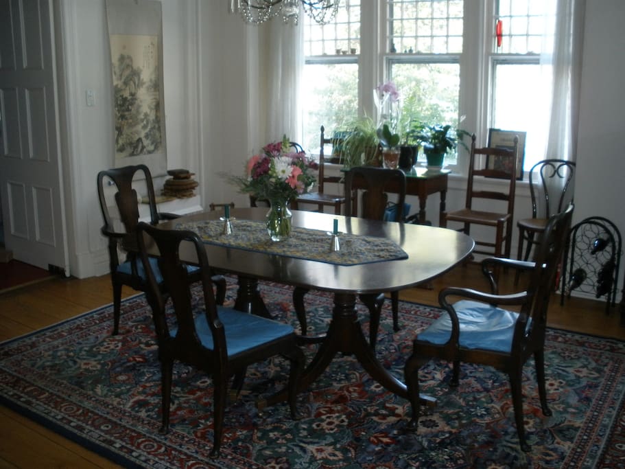 Dining room with many windows and generous space to seat six