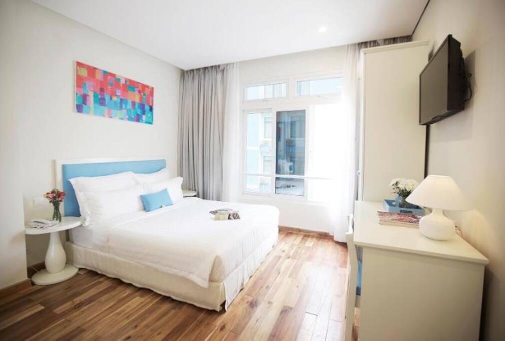 Bedroom:
- 1 king size bed with super comfy mattress.
- Big window for natural light and city view
- Working desk
- TV with cable
- Wardrobe with 5 hangers.
- 01 Safe