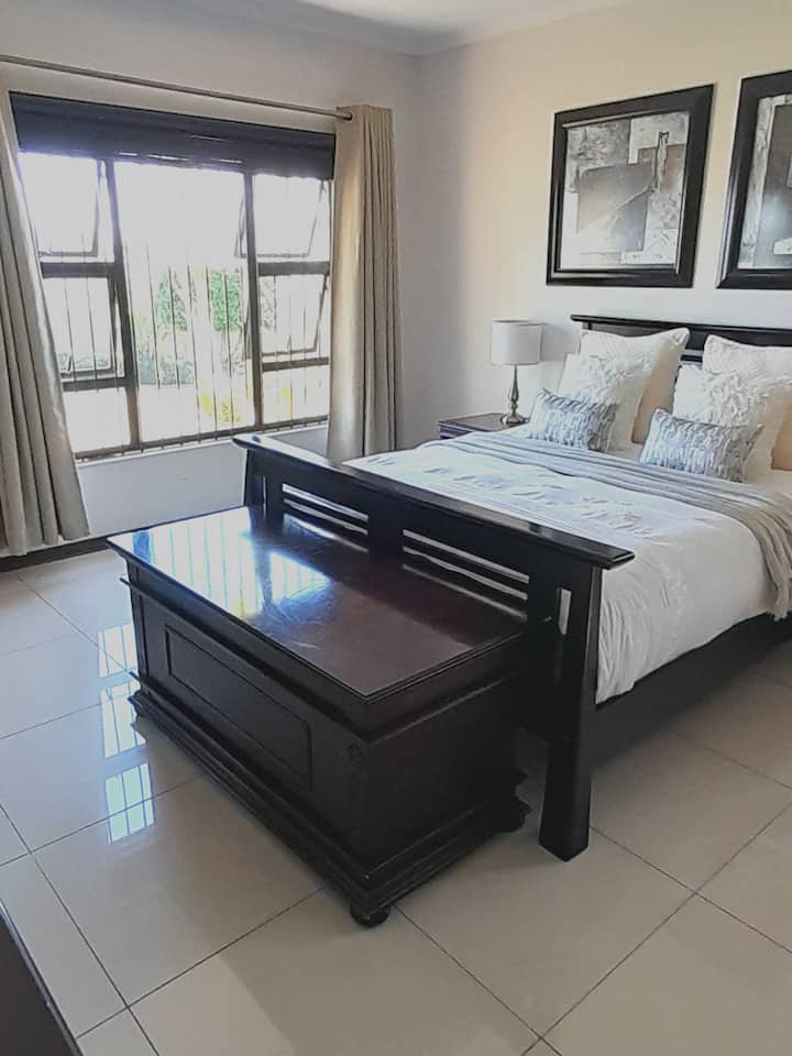 Bedroom 1, queen bed, ensuite shower + bath tub, TV, ceiling fan