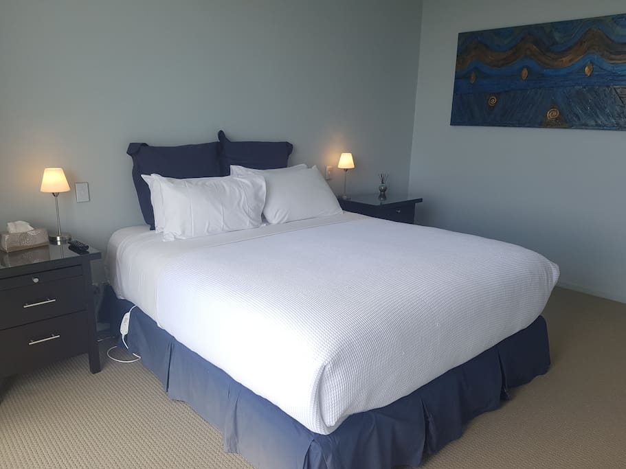 Master bedroom with lake views, balcony and ensuite bathroom