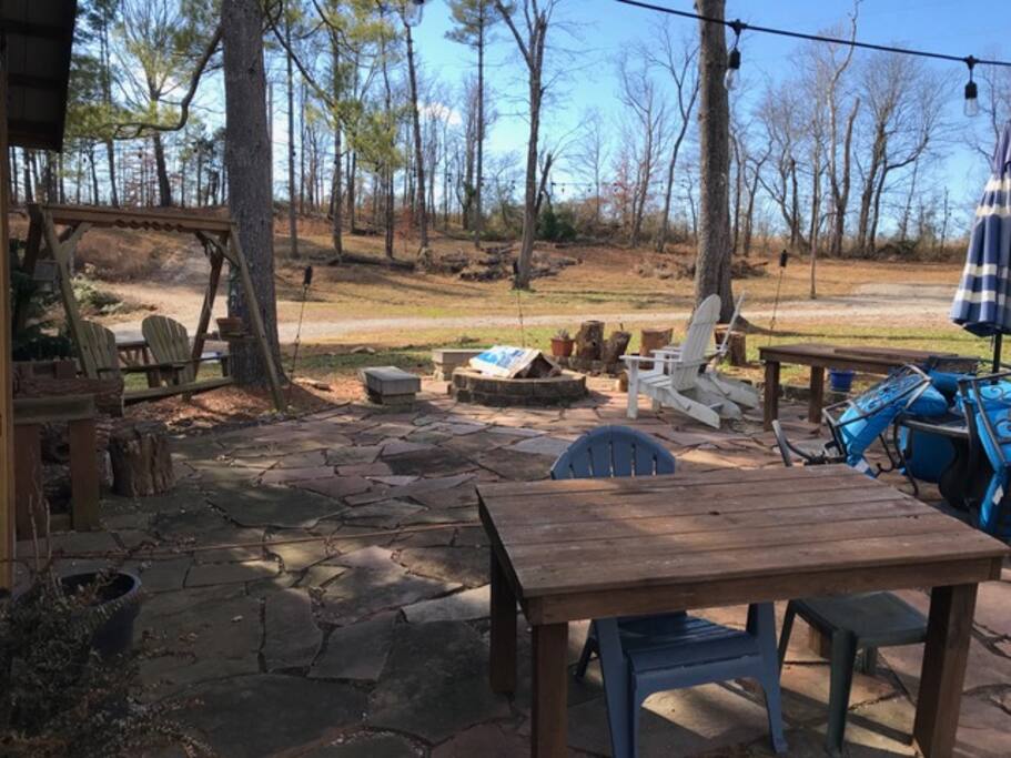 Outdoor patio w plenty of seating and a fire pit