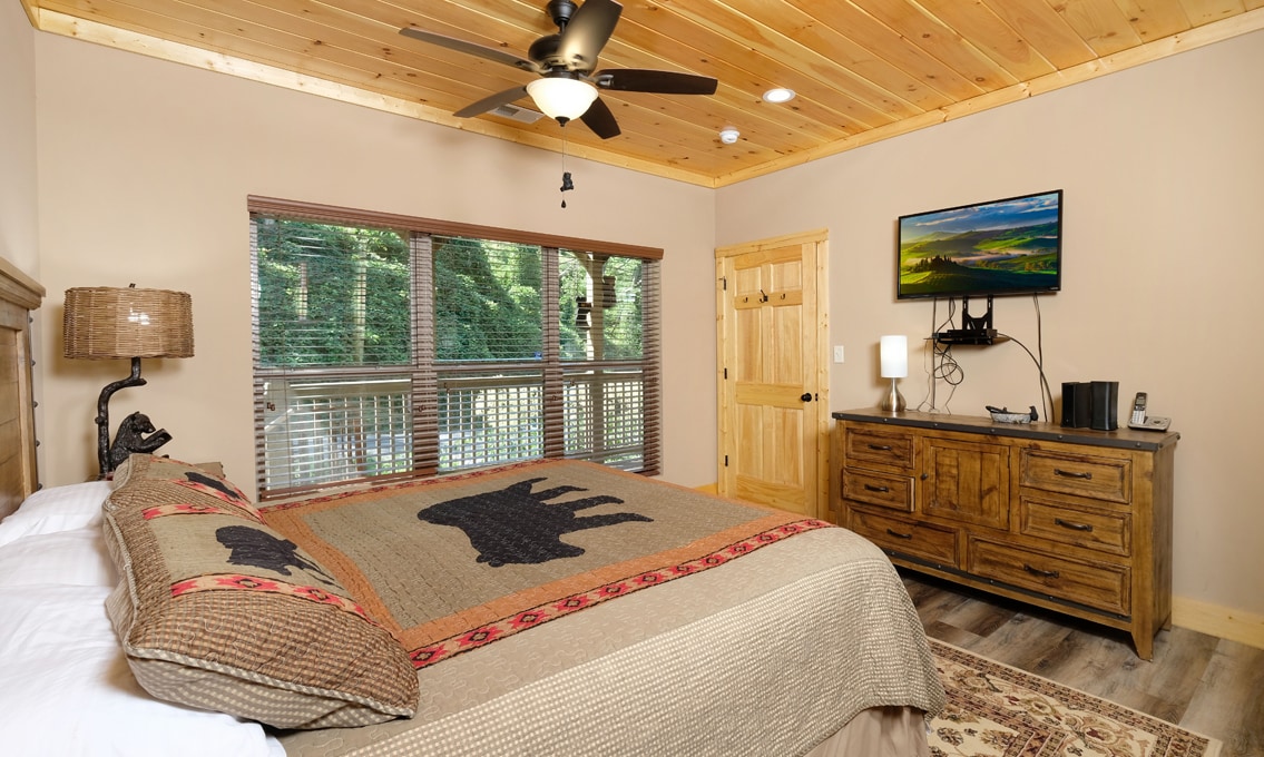 חדר שינה למטה עם מיטת קינג סייז וטלוויזיה חכמה Roku