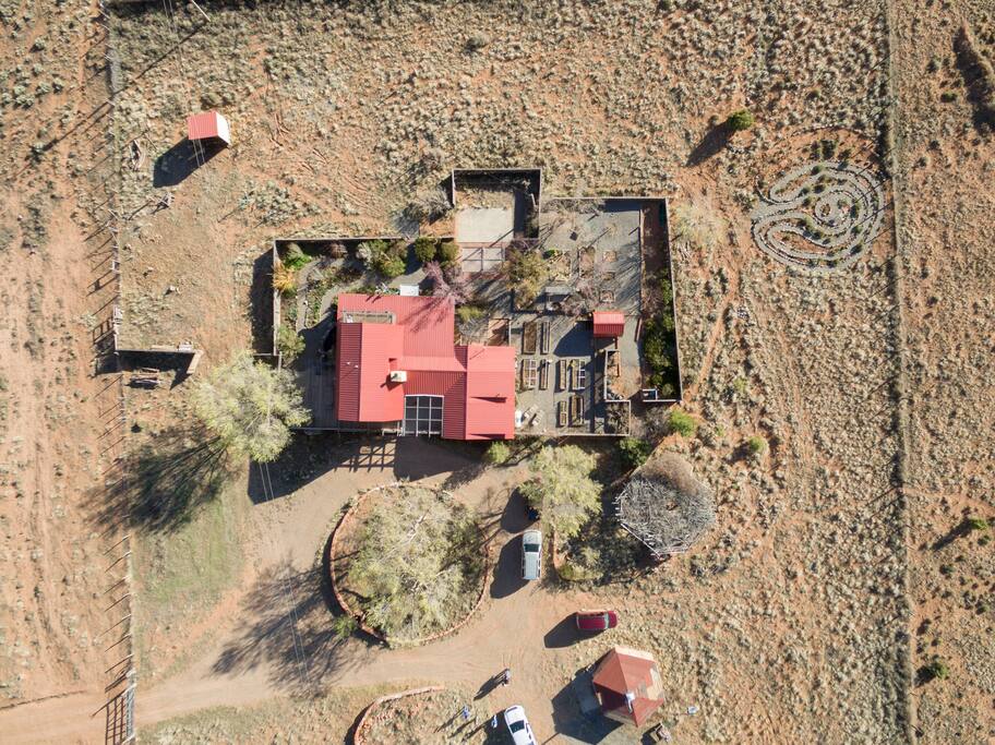 This drone photo was taken by our photographer friend, Mark Lipcynski. The hogan is towards the bottom right. The outlines of the labyrinth are visible in the top right corner. Our home and gardens are in the center of the photograph.
