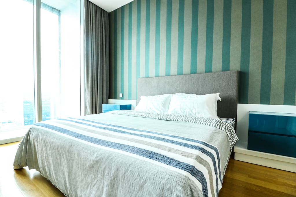 Master bedroom with a King size bed soothing and air-cond along with a breath taking city view