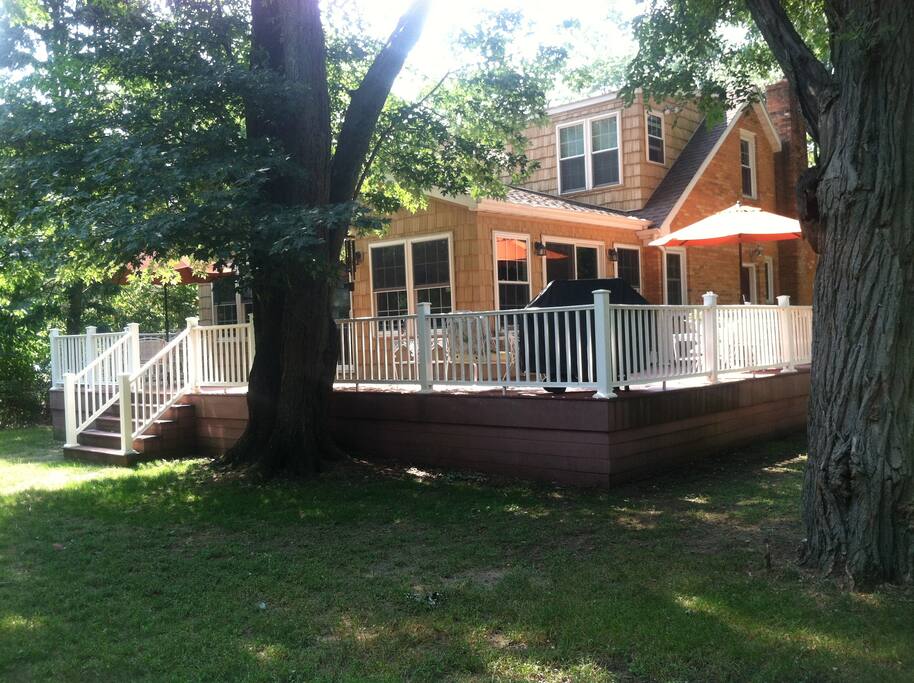 Back and side of home showing large wrap around deck off of family room/kitchen. Nice for grilling on the bbq and relaxing.