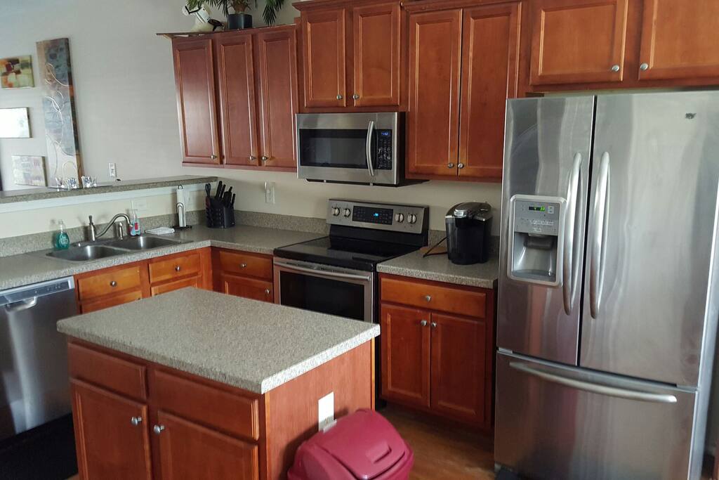 Spacious Kitchen With Island and Stainless Steel Appliances