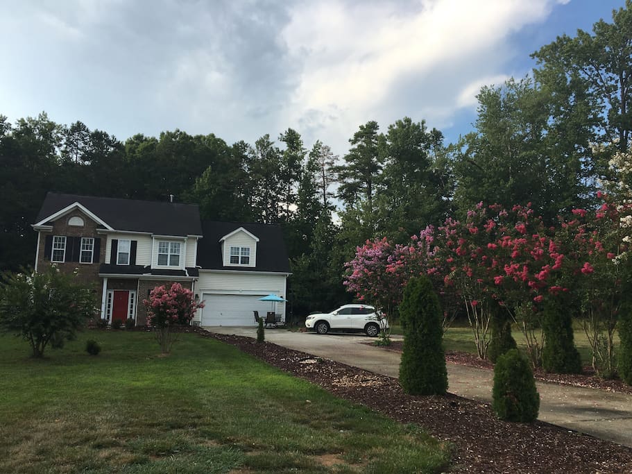 Front of house with beautiful trees.
