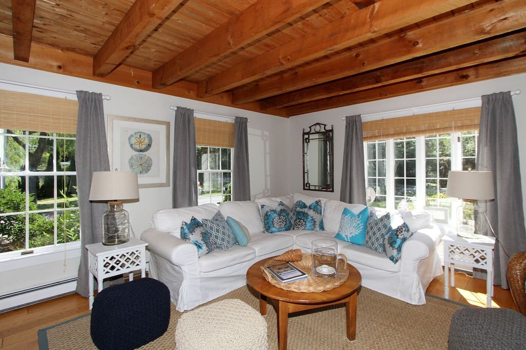 The living room features a sectional sofa and plenty of light