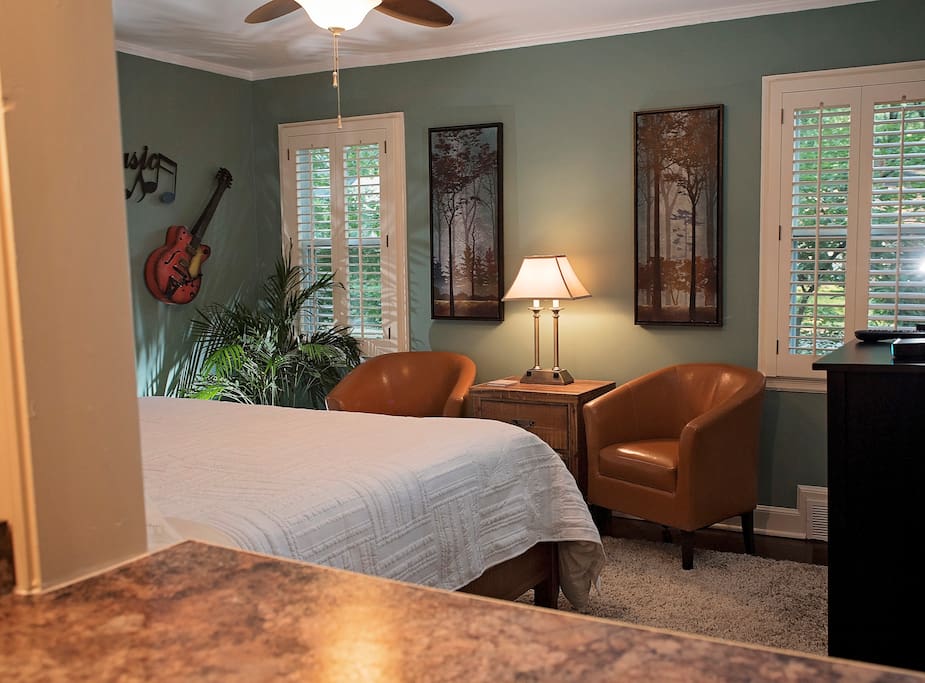 Private 1 BR/1 BATH suite for two. Seating area at foot of bed.