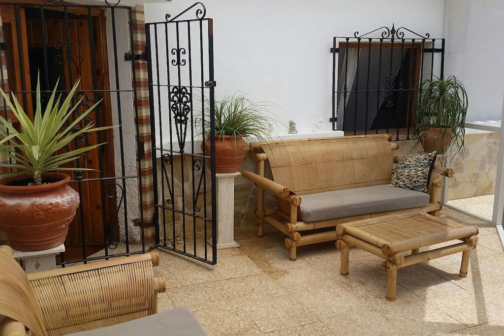 Shaded terrace area with bamboo seats and mosquito netted porch