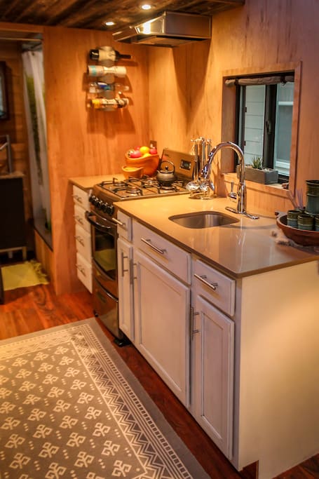 Quartz counters for kitchen prep, and gas stove for cooking.