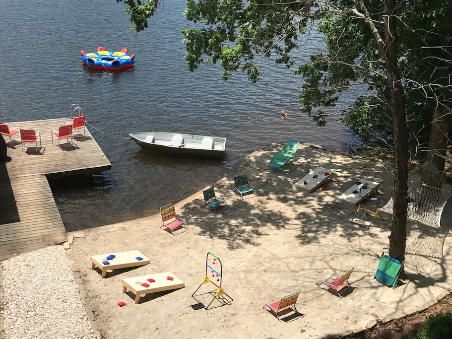 1,000 square foot beach area with hammock, ladderball, and two sets of cornhole boards for your use