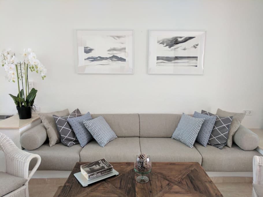 Living room with adjoining dining area next to open-plan kitchen