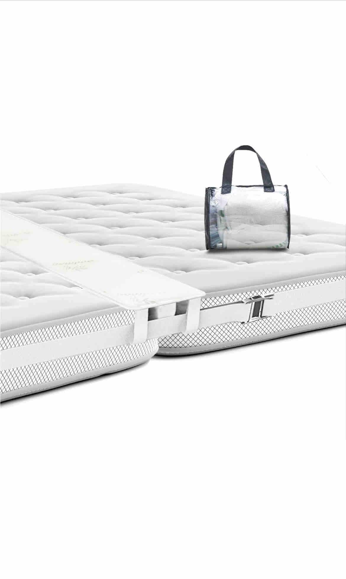 A spacious king bed is configured from two Twin XL beds, held together with a mattress pad and straps. A clear, stylish tote bag is positioned on top, adding a practical touch to the inviting bedding.