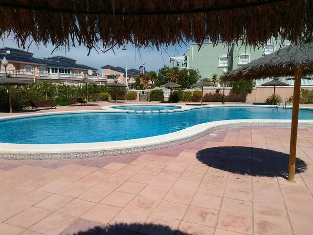 Sunny apartment - pool, private sundeck & parking