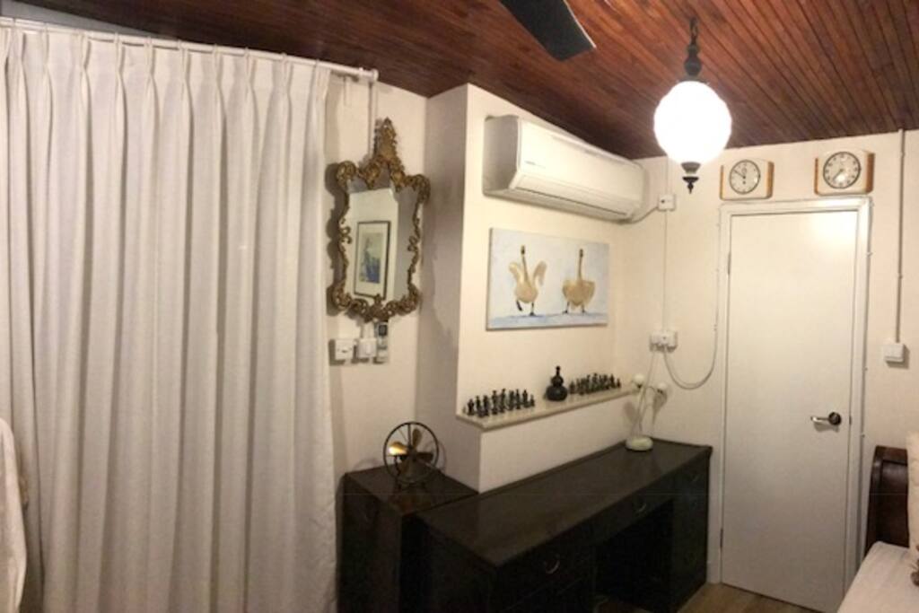 A single bedroom with antique furniture. A generous cupboard and desk for work. An on suite bathroom with shower.