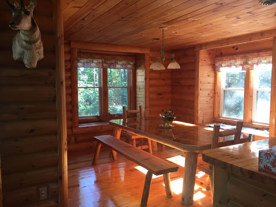 Custom kitchen table comfortably seats 6-8 people with beautiful views of the natural surroundings.