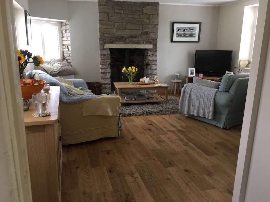 Living room with oak floor,two sofas & wood burner