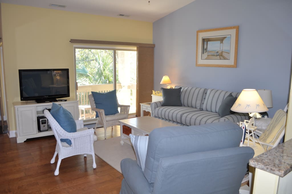 Bright and spacious living room has a flat screen TV & DVD player.