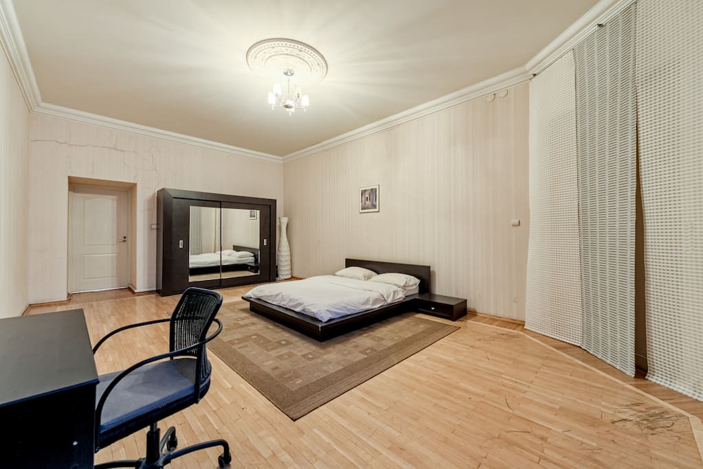Bedroom with large wardrobe and desk and roling chair