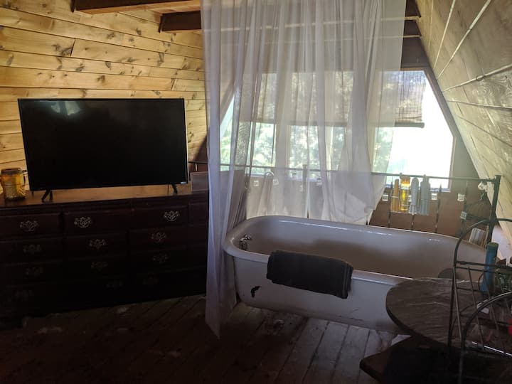 Upstairs bed with bathtub