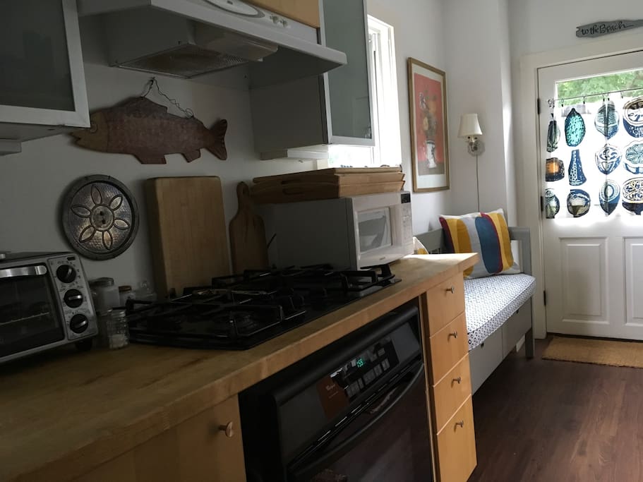Sunny galley kitchen with gas stove