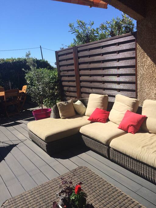 Terrasse côté sud de 35 m2 avec store Manuel et grand parasol sur la grande table en été