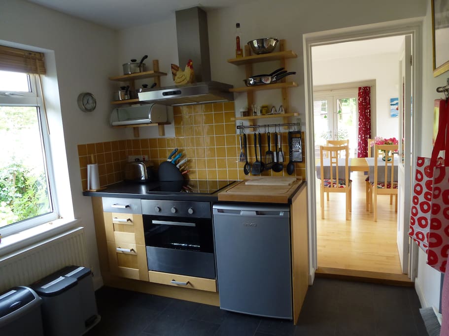 Kitchen with fridge, dishwasher, washing machine, microwave and conventional oven.