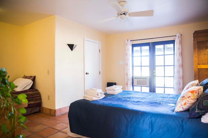 Room 2 with one queen and one twin bed and a private bathroom