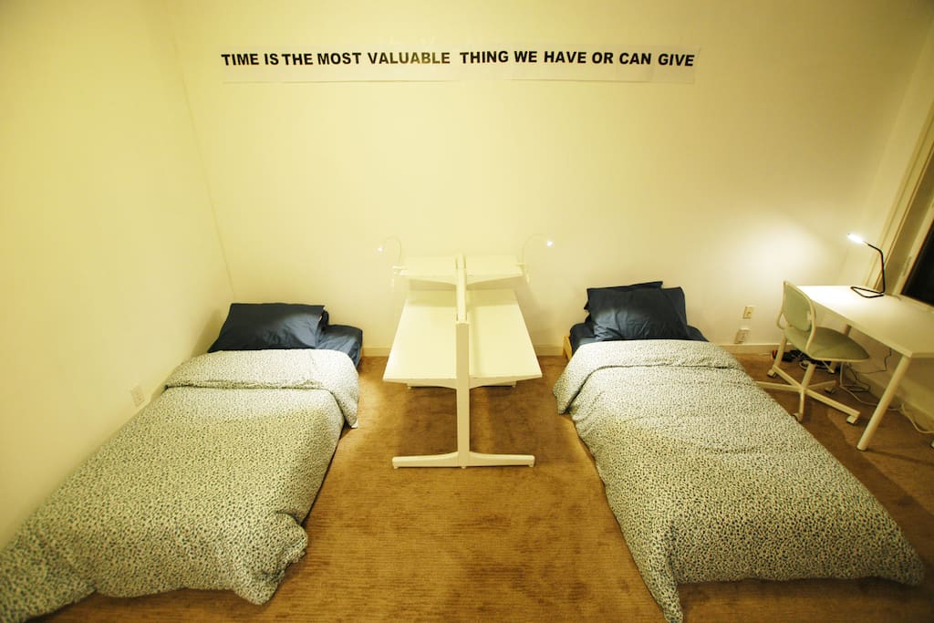 Two twin sized beds and a desk. Each twin sized bed comes with its own LED lamp for added lighting control