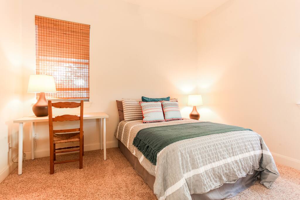 Bedroom with full size bed and desk