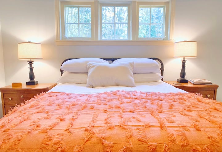 Downstairs bedroom which includes a full bathroom with claw foot tub and shower combination.