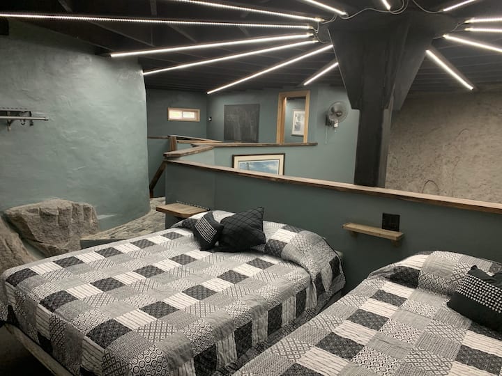 Two queen beds in an open loft.