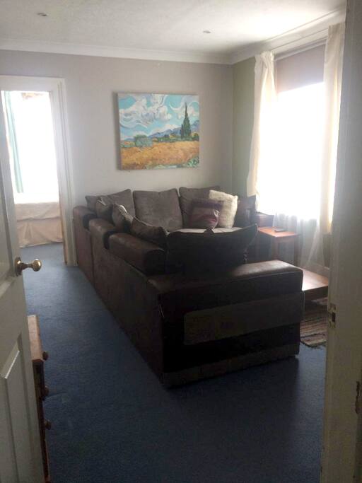 Lounge area with TV and 7ft comfy corner sofa